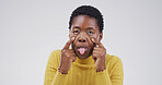 Goofy, tongue out face and portrait of black woman in studio with open eyes, silly and comic facial expression. Crazy, joke and African female person with comedy gesture for humor by white background