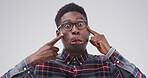 Pointing, silly and portrait of black man in studio with funny face for emoji, comedy and humor. Mockup space, happy and isolated person with joke, crazy and goofy expression on white background