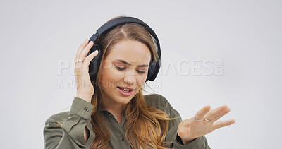 Buy stock photo Headphones, dancing and woman in studio with music, playlist or radio online with rhythm. Streaming, entertainment and person with audio tech for listening to song or album by white background.