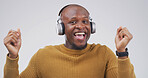 Black man, headphones and dancing with smile in studio with album, streaming or song on white background. African person, portrait and listen to music with subscription, radio or rhythm in Nigeria