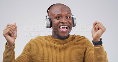 Buy stock photo Black man, headphones and dancing with smile in studio with album, streaming or song on white background. African person, portrait and listen to music with subscription, radio or rhythm in Nigeria