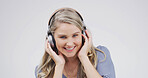 Woman, headphones and happy in studio portrait, digital streaming and album on white background. Person, smile and listen to music playlist, radio and audio subscription with mock up space in Germany