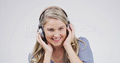 Buy stock photo Woman, headphones and happy in studio portrait, digital streaming and album on white background. Person, smile and listen to music playlist, radio and audio subscription with mock up space in Germany