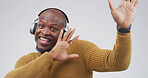 Black man, happy and dancing with headphones in studio with album, streaming or song on white background. African person, portrait and listen to music with subscription, radio or rhythm in Nigeria