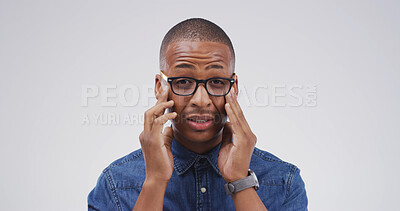 Buy stock photo Black man, headache and glasses in studio portrait with mockup space, tired or vertigo on white background. Person, chronic migraine and burnout with brain fog, eye pain and temple massage in Kenya