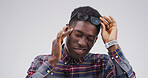 Black man, headache and glasses with stress in studio with mockup space, tired or vertigo on white background. African person, chronic migraine and burnout with brain fog, eye pain and temple massage