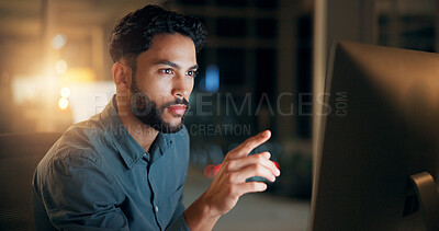 Buy stock photo Business man, reading and pointing at computer at night for trading, investment or deadline. Indian person, trader or employee for stock market research, finance planning or serious at workplace