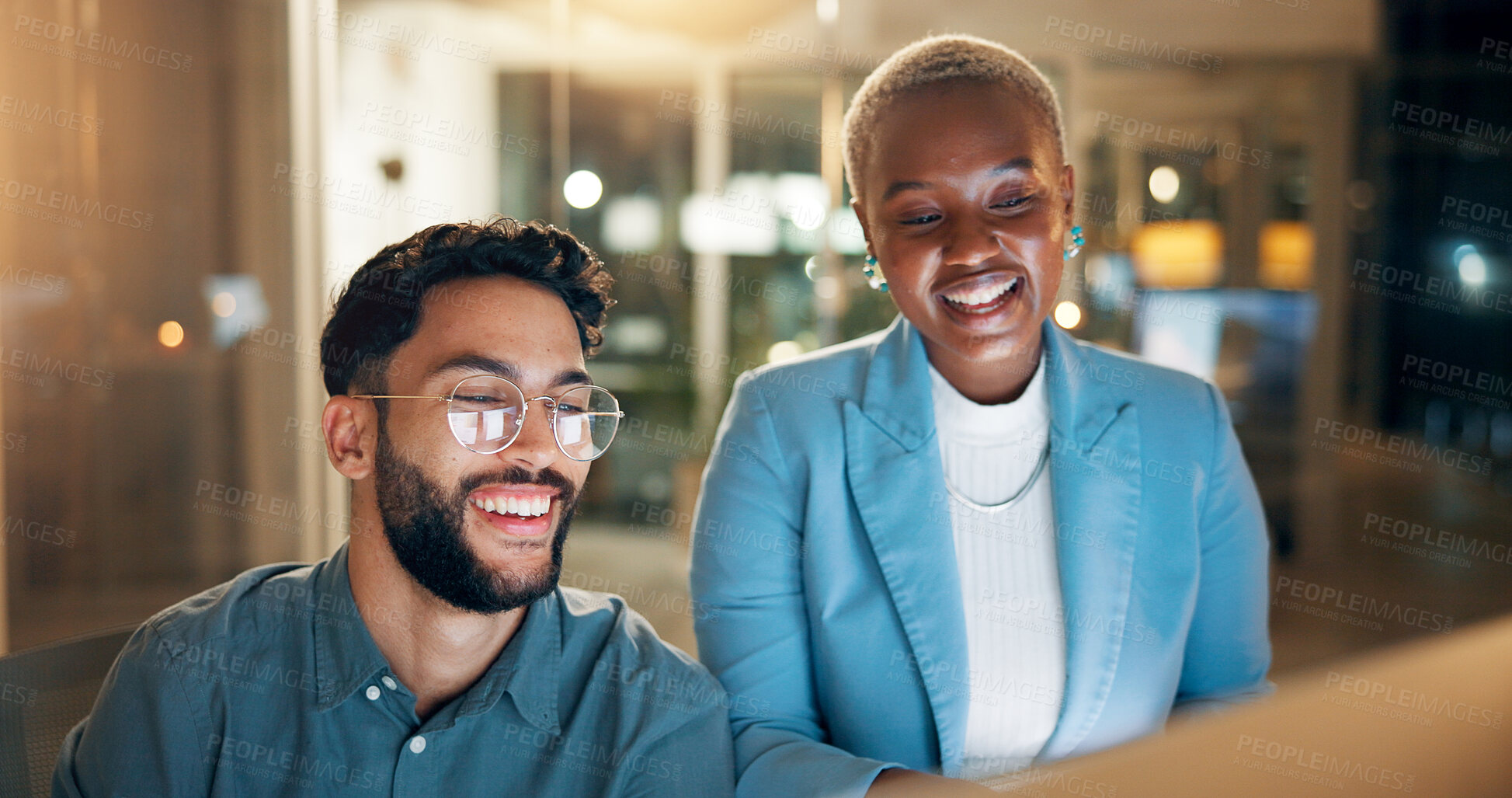 Buy stock photo Computer, funny and night with business people in office together for development or planning. Feedback, laughing or review with man and woman in workplace for collaboration or project deadline