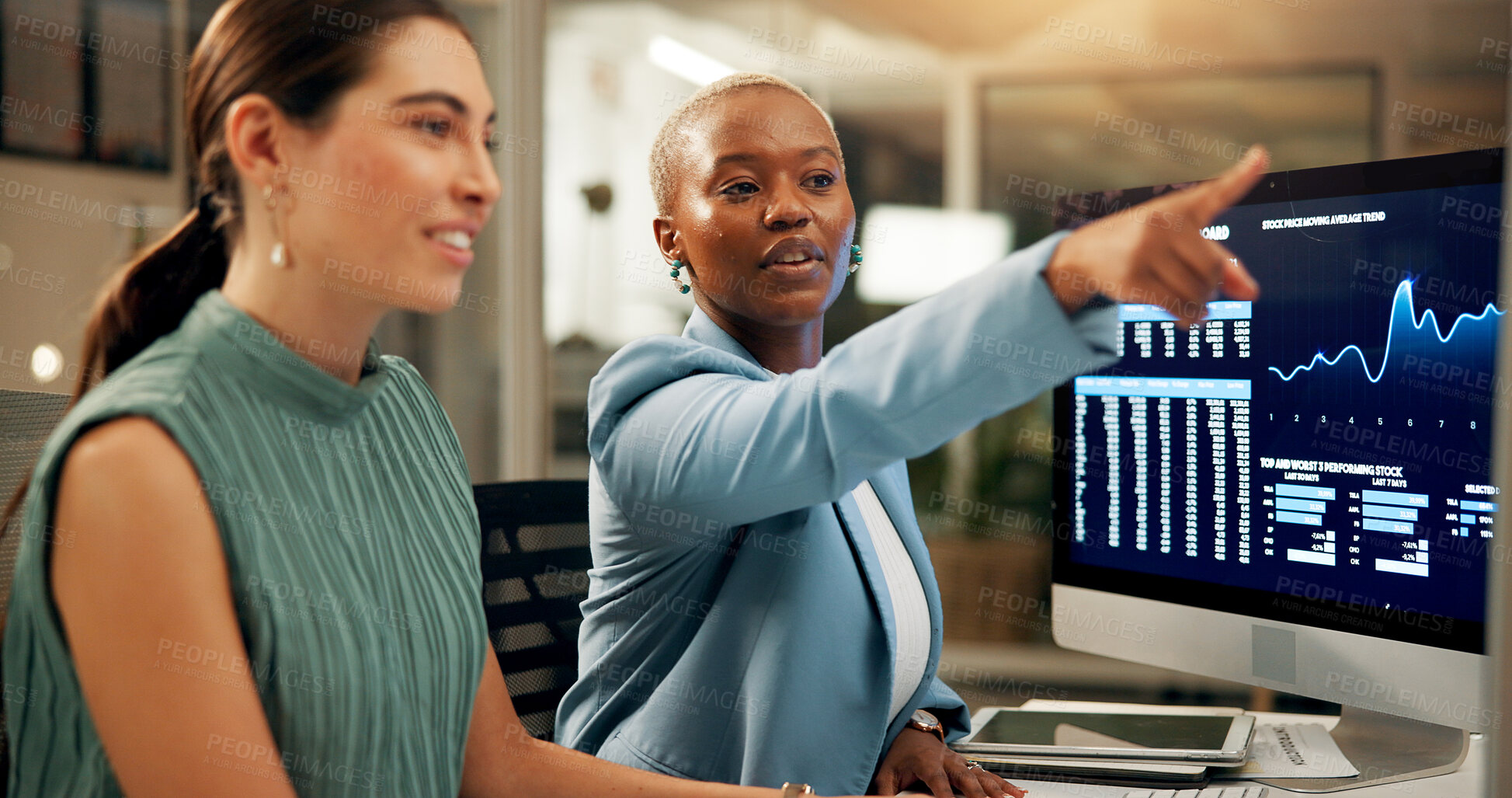 Buy stock photo Computer, night and pointing with business women in office together for stock market trading. Conversation, feedback or screen with employee people in workplace for investment or portfolio management