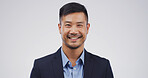 Business, portrait and smile of man on studio space for career development or job opportunity. Corporate, professional and suit with happy Asian employee isolated on white background for satisfaction