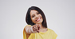 Portrait, pointing to you and woman in studio, confidence and selection on white background. Smile, hand gesture and person with happiness, decision and encouragement with choice, emoji and promotion