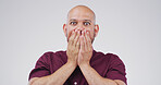 Surprise, shock and portrait of scared man with fear, mind blown or terror on white studio background. Wow, person or cover mouth with face expression for fake news, danger or omg with horror story