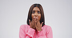 Scared, surprise and portrait of woman in studio with omg, wtf or wow reaction for news. Emotion, shcoked and female person with hands covering mouth for rumor or announcement by white background.