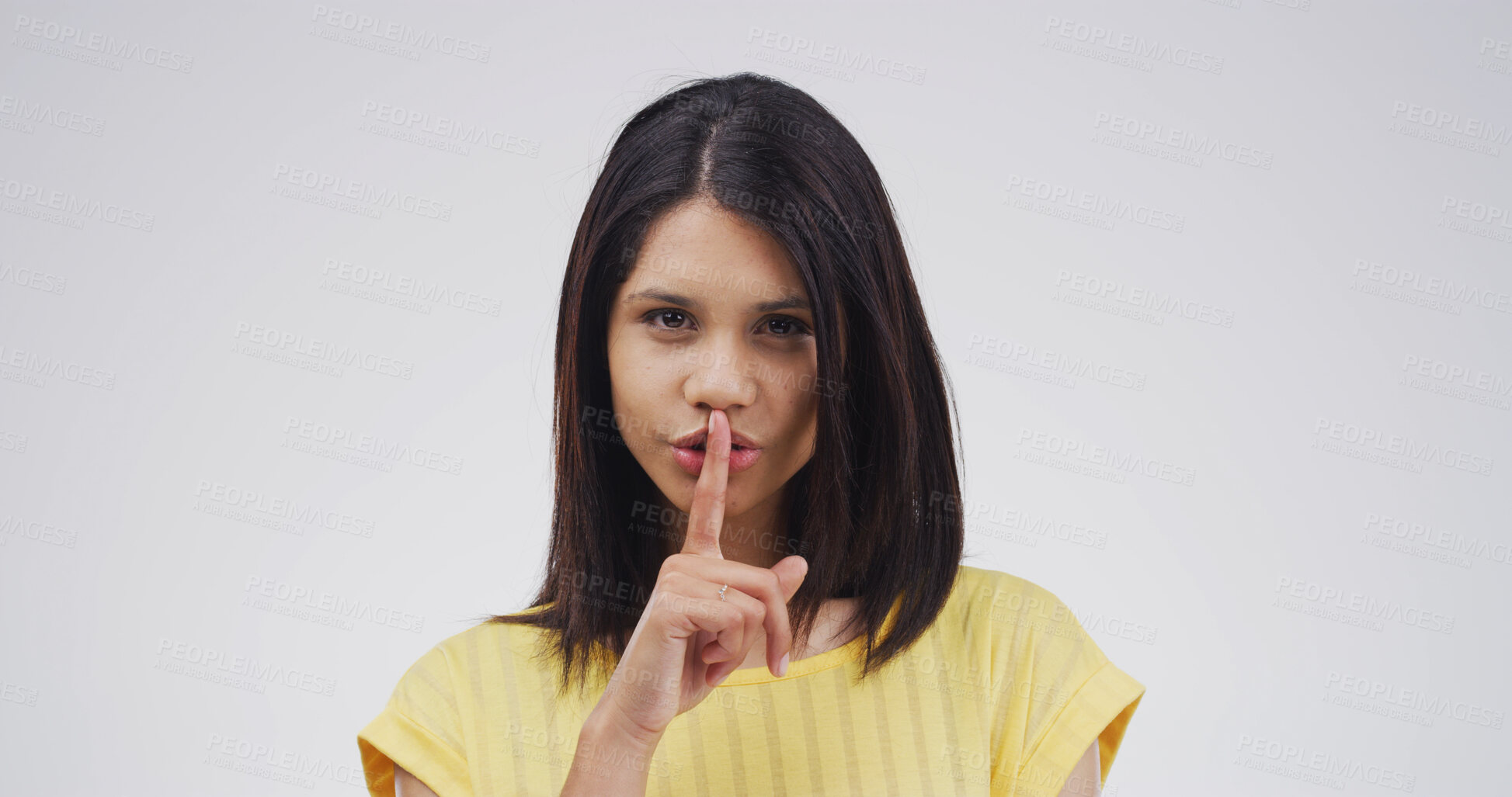Buy stock photo Portrait, student and woman with secret, studio and gesture for privacy, confidential or mysterious. White background, shush and person with sign for silence, emoji and finger for shut up or reaction