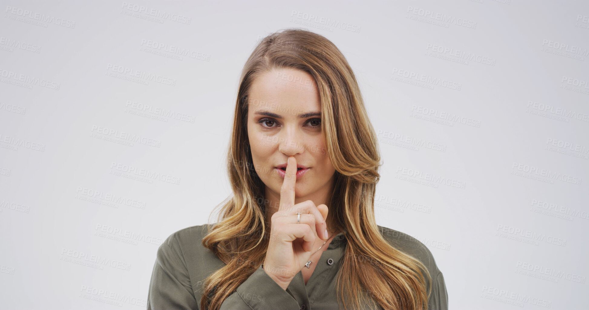 Buy stock photo Portrait, finger on lips and woman with secret, shush and privacy sign on white studio background. Space, gesture and person with emoji, silence and whisper with gossip, confidential and quiet