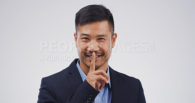 Buy stock photo Businessman, portrait and finger with hush, studio and silence for mystery announcement. Model, gossip and secret with corporate rumor, whisper and gesture for news and privacy on white background