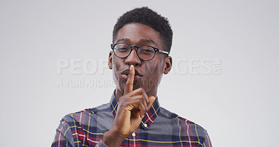 Buy stock photo Happy, portrait and black man in studio with secret, gossip or confidential hand gesture for privacy. Quiet, smile and African male person with finger on lips for noise control by white background.