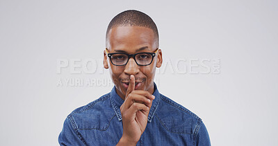 Buy stock photo Portrait, black man and shush in studio for secret, gossip or stop on white background space. Quiet, noise and person with finger on lips for privacy, confidential news and silence sign for whisper
