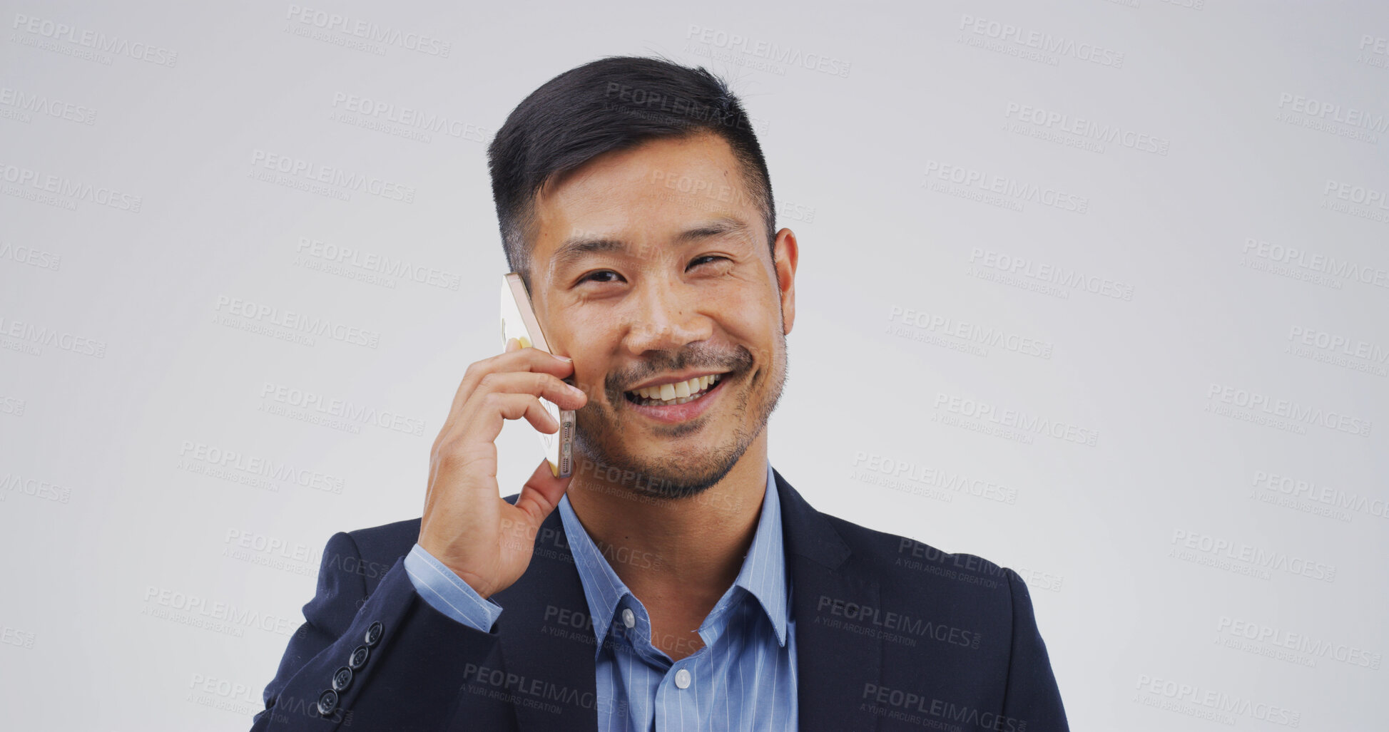 Buy stock photo Businessman, phone call and happy in studio for talk, mock up space and portrait on white background. Asian person, lawyer and attorney with legal consultation, advice and smartphone in Indonesia