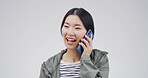Happy, asian woman and studio with phone call for communication or chat on a white background. Female person, listening or laughing with mobile smartphone for friendly discussion on mockup space