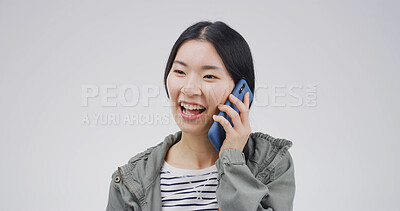 Buy stock photo Happy, asian woman and studio with phone call for communication or chat on a white background. Female person, listening or laughing with mobile smartphone for friendly discussion on mockup space