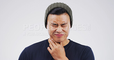 Buy stock photo Allergy, hurt and man with sore throat on studio space for cold, flu or virus symptoms. Asthma, bacteria or Asian person isolated on white background with neck pain, thyroid inflammation or injury