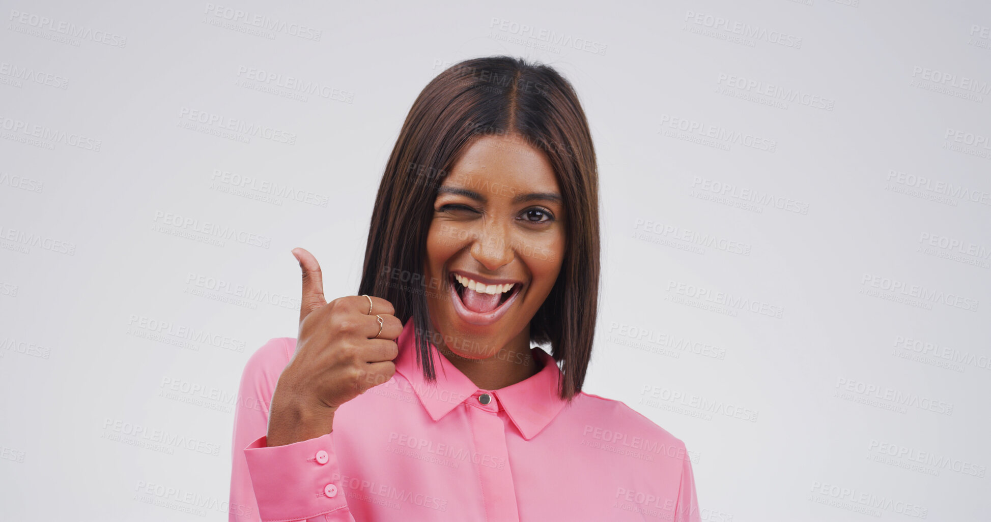 Buy stock photo Happy woman, portrait and thumbs up with wink in studio for good job on a white background. Face, female person or model with smile, like emoji or yes sign for welll done, thank you or OK on space