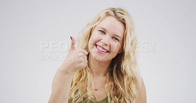 Buy stock photo Portrait, woman and emoji with thumbs up in studio for good news, agreement and like feedback. Space, female person and hand gesture for thank you, support vote and show decision on white background