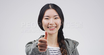 Buy stock photo Asian woman, portrait and smile with thumbs up in studio, motivation or promo with praise. Agreement, success or hand gesture for yes, thank you or feedback with sign for review on white background