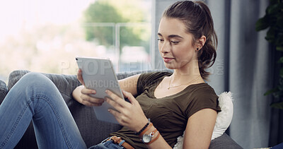 Buy stock photo Tablet, relax and woman on sofa in home reading ebook, blog or research on app for weekend activity. Smile, calm and female person with digital technology for social media in living room at apartment
