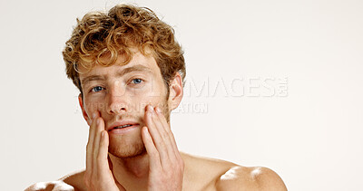 Buy stock photo Facial, portrait and skincare with man in studio for grooming, hygiene or wellness routine. Beauty, cosmetics and lotion with person on white background to apply face cream or moisturizer on space