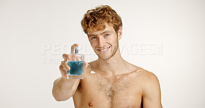 Buy stock photo Studio, portrait and happy man with perfume for fragrance, grooming or hygiene on white background. Cologne, fresh scent or model with cosmetics product in bottle for self care, beauty or smell clean