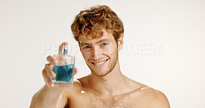 Buy stock photo Bottle, smile and man with perfume for hygiene, grooming or scent on white studio background. Cologne mockup, fresh fragrance or model with cosmetic product in portrait, beauty or odor to smell clean
