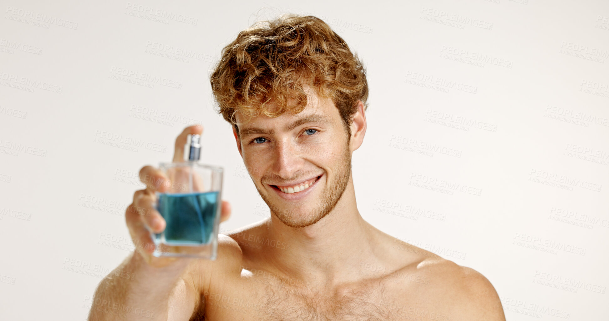 Buy stock photo Bottle, smile and man with perfume for hygiene, grooming or scent on white studio background. Cologne mockup, fresh fragrance or model with cosmetic product in portrait, beauty or odor to smell clean