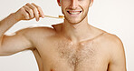 Dental care, smile and man brushing teeth in studio for fresh breath, wellness or plaque removal. Morning, oral health and person with toothbrush for cleaning mouth with hygiene by white background.