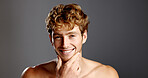 Man, beauty and smile in portrait for skincare, beard and dermatology on a grey background. Facial hair, self care and male model happy with cosmetics, confidence and grooming with hand on face