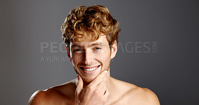 Buy stock photo Man, beauty and smile in portrait for skincare, beard and dermatology on a grey background. Facial hair, self care and male model happy with cosmetics, confidence and grooming with hand on face