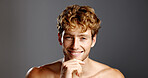 Man, skin care and hand on chin in portrait for confidence, beard and dermatology on a grey background. Hairstyle, pride and male model happy with cosmetics, shirtless and grooming by mockup space