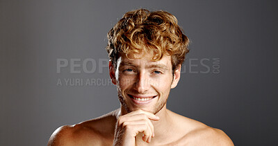 Buy stock photo Man, skin care and hand on chin in portrait for confidence, beard and dermatology on a grey background. Hairstyle, pride and male model happy with cosmetics, shirtless and grooming by mockup space