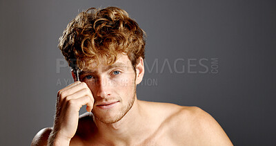 Buy stock photo Man, beauty and hair in portrait with skincare, beard and dermatology on a grey background. Shirtless, self care and serious male model with cosmetics, confidence and grooming with hand on face