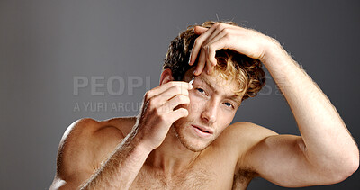Buy stock photo Skincare, eyebrows and tweezers with face of model for grooming, hygiene or hair removal in studio. Cosmetic, treatment and facial growth with man, beauty tool and morning routine on gray background
