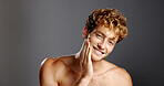 Portrait, man and smile for skincare in studio for natural beauty, facial treatment and results. Happy, male person and confidence with dermatology shine, hair removal and wellness on gray background