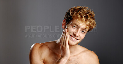 Buy stock photo Portrait, man and smile for skincare in studio for natural beauty, facial treatment and results. Happy, male person and confidence with dermatology shine, hair removal and wellness on gray background