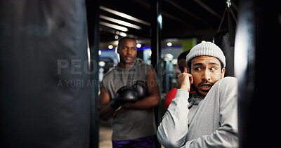 Buy stock photo Boxing, coach or teach defense in gym with position, group session or training at punching bag. Man, fitness or athletes in sport center for instruction, combat technique or learning to deflect
