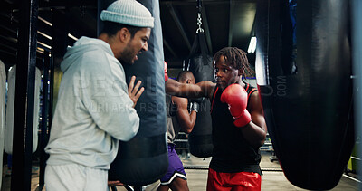 Buy stock photo Sport, men and personal trainer in gym, punching bag or practice for competition, boxing and active. Power, fighter and training with instructor for performance, athlete and workout in fitness center