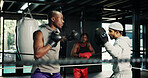 Gym, fitness and training with people in boxing ring for sports, self defense or sparring. Boxer, challenge and fight with men punching in combat for competition, exercise or performance as athlete
