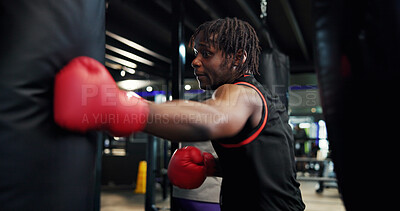 Buy stock photo Boxer, man and workout with punching bag in gym for fight training, combat sports and technique. Athlete, fitness and black person with boxing at health club for conditioning and endurance exercise
