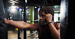 Black man, punching bag and boxing for workout at gym with power, challenge or martial arts. African person, athlete or training with fist, fight or contact sport with equipment for exercise at club