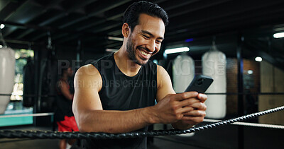 Buy stock photo Fitness, happy man and phone in boxing ring for contact, training meme or latest sports news on break. Boxer, rest and mobile at gym for social media, status update and funny post on exercise forum