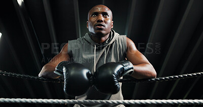 Buy stock photo Sport, boxing ring and tired black man on rope for relax, rest or health recovery for fitness. Athlete, boxer and break in gym with fatigue, sweat or fight challenge for intense workout in low angle